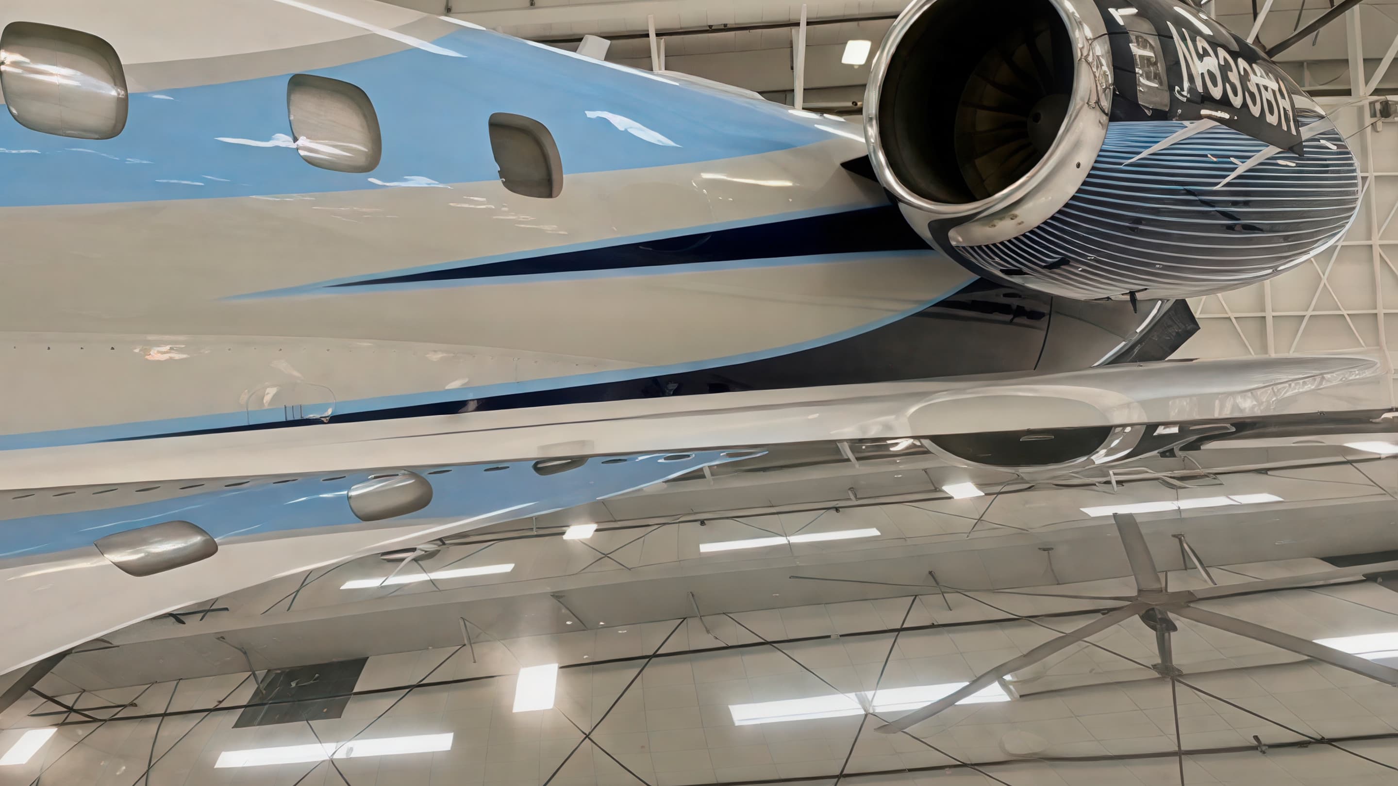 Polished aircraft engine intake and reflective brightwork inside a hangar