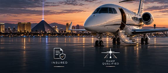 Business aircraft on a wet Las Vegas ramp with insured and ramp-qualified badges